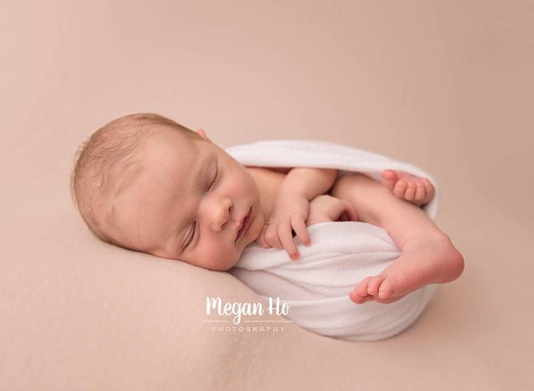 sleeping baby boy wrapped in white in nh newborn session