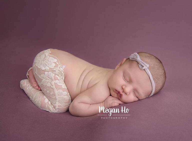 little baby girl sleeping on mauve blanket in lace pants in nh studio