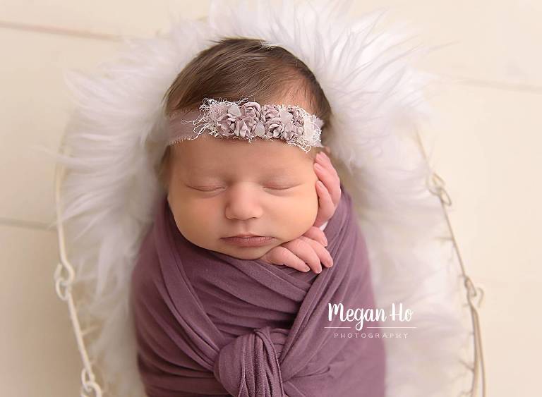 NH sleeping newborn session in purple wrap on white floor