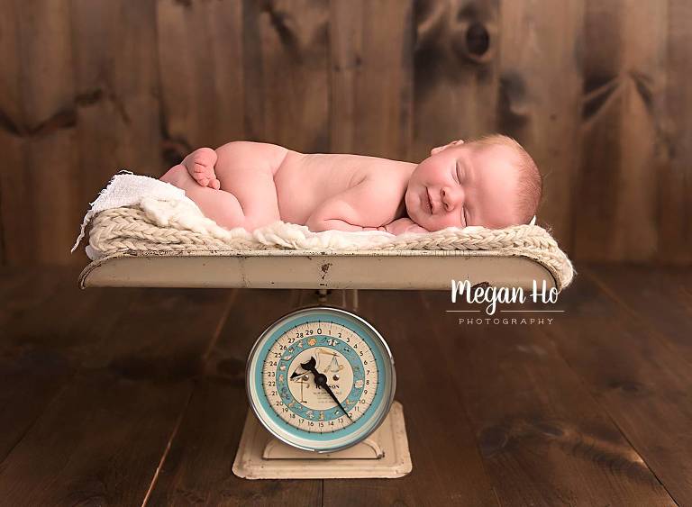 baby boy sleeping on antique scale in new hampshire newborn session