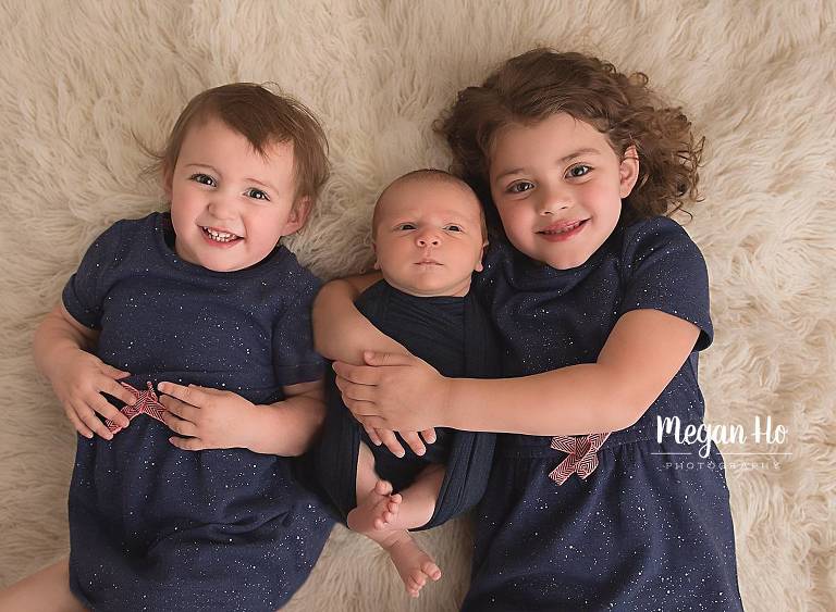 Baby wrapped in navy with older sister southern nh newborn session