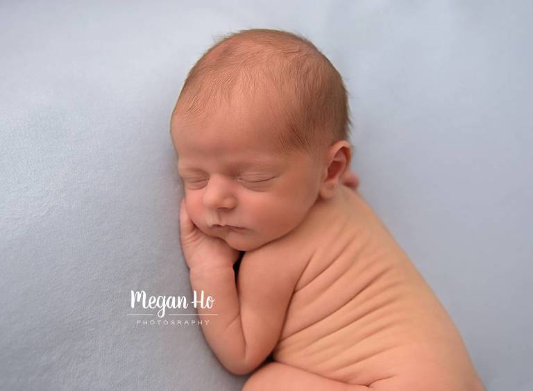 nh newborn baby boy sleeping on blue fabric