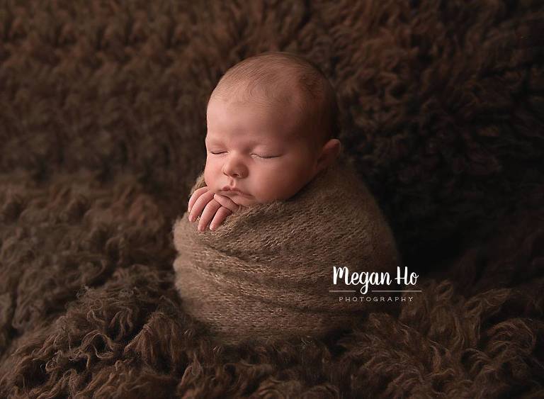 sleeping baby boy in newborn session new hampshire wrapped in brown