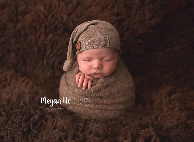 squishy baby swaddled on brown fluffy rug nh studio session