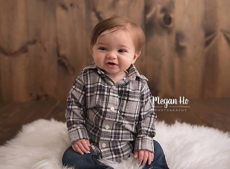 smiling little boy in plaid shirt in sitter milestone session bedford nh