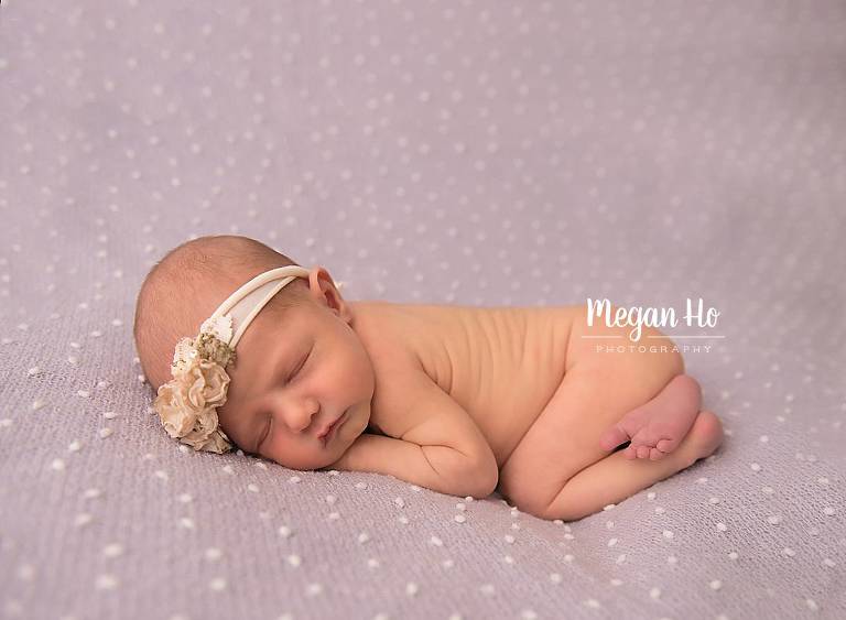 nh newborn session baby girl sleeping on purple dotted blanket