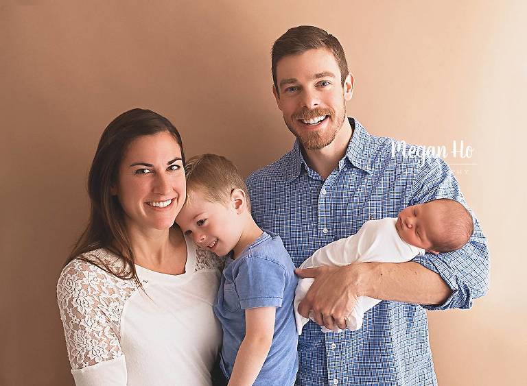 happy family of four in nh studio for newborn session