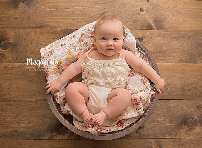 four month milestone session baby girl in bowl in bedford nh