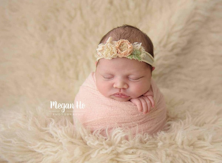 baby girl in potato sack wrapped in blush pink in New Hampshire studio