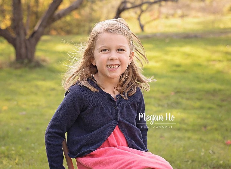 four year girl sitting in chair in fall session in Amherst nh