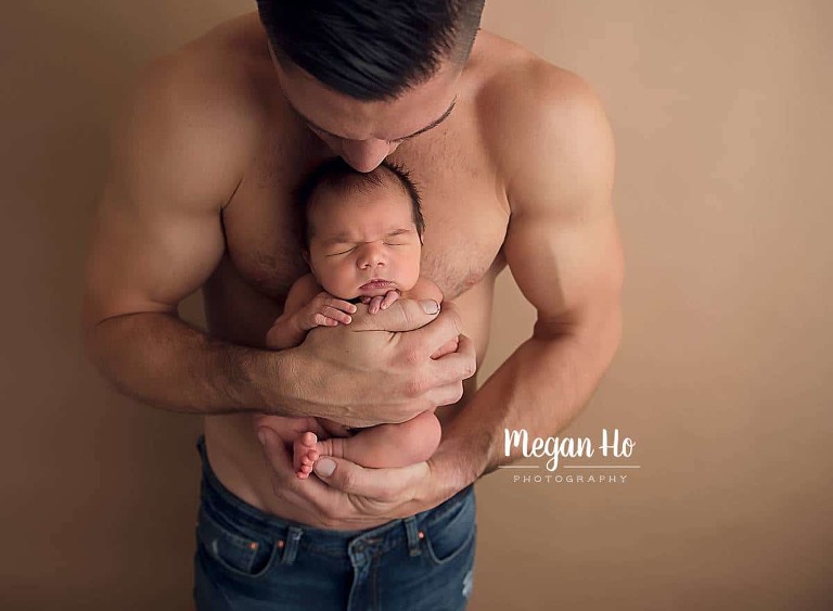 Dad holding newborn baby boy skin to skin in nh studio