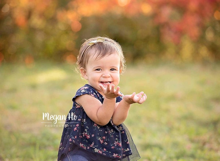 smiling little girl in blue flower shirt in nh fall session