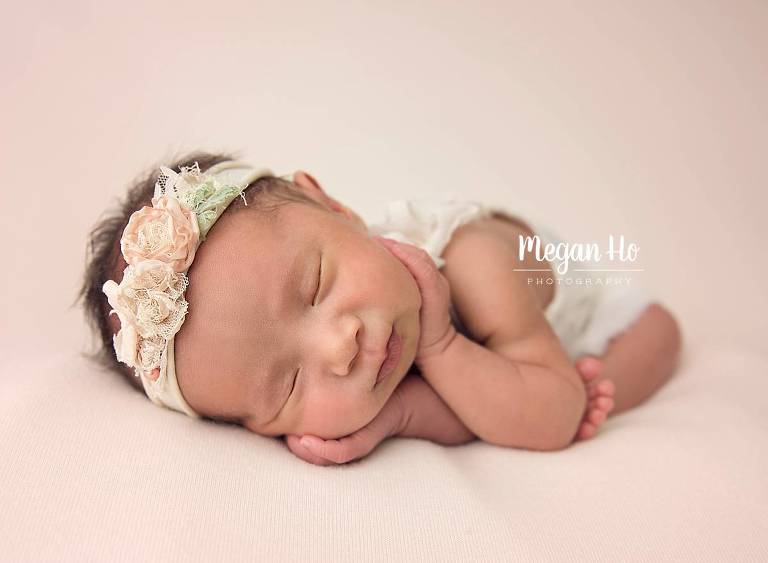 timber pose in bedford nh sleeping newborn girl with hands on sides of face