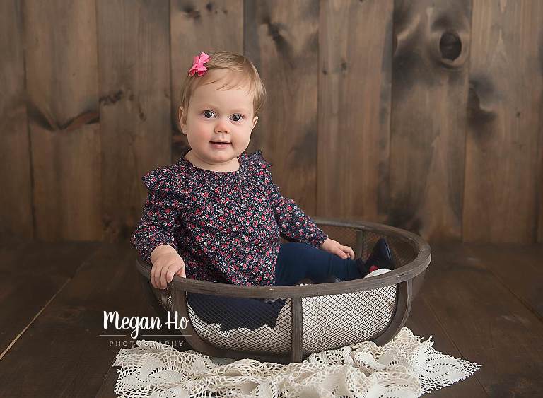 studio nh session baby girl sitting in wooden bowl