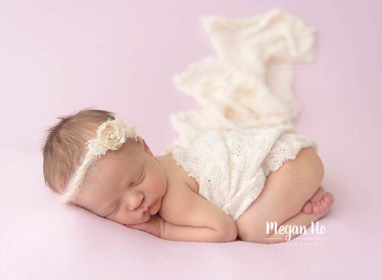 bum up pose newborn girl with lace wrap on pink backdrop in bedford nh