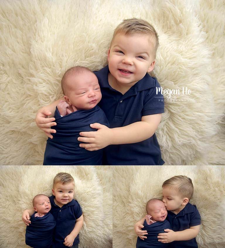 big brother in navy smiling kissing and snuggling newborn baby boy in new hampshire