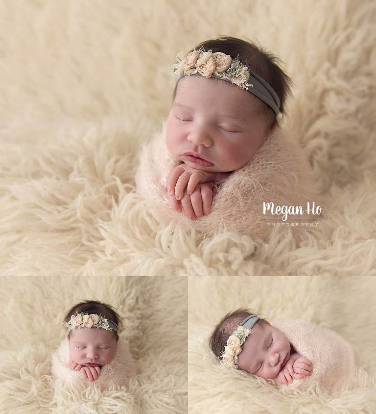 potato sack pose wrapped baby in light pink snuggled in white fluffy rug