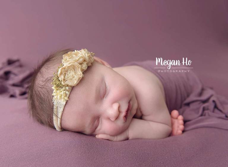 happiest sleeping baby on purple with cream flower headband