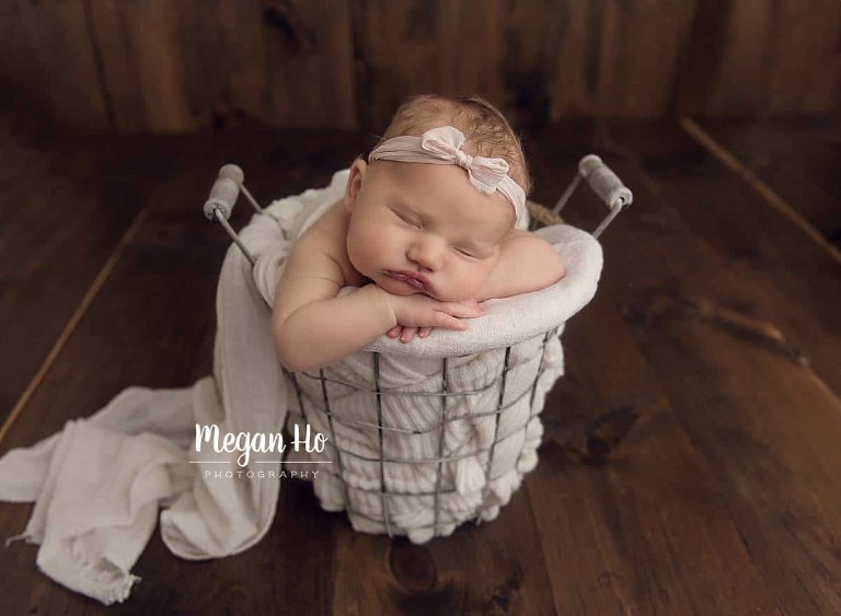 New Hampshire baby girl in bucket on wooden floor