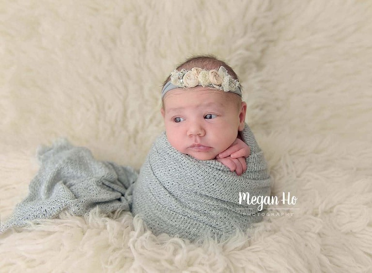 all wrapped up in potato sack in grey on fluffy rug