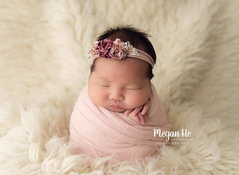 potato sack posing newborn girl in pink on white fluffy rug in bedford nh