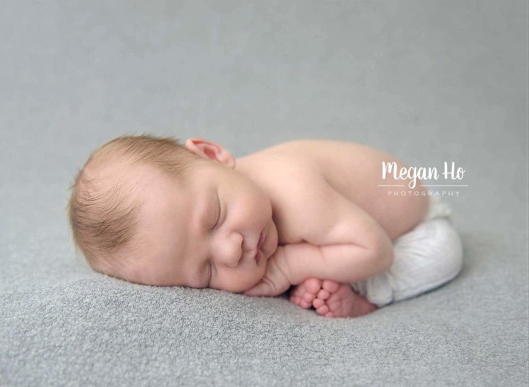 sweet little boy sleeping in little pants with tiny toes showing