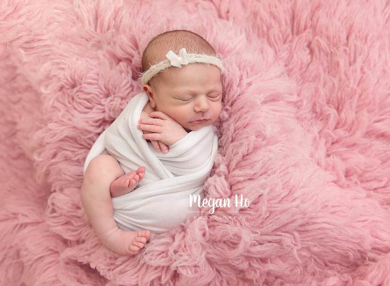 nh newborn session pretty girl in white sleeping on pink fluffy rug with dainty bow