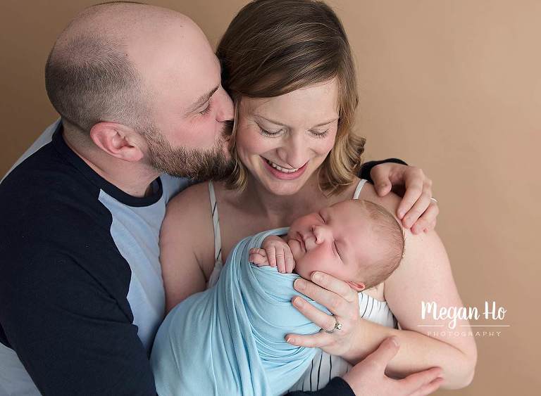 mom and dad lovingly becomes a family of three in New Hampshire newborn session