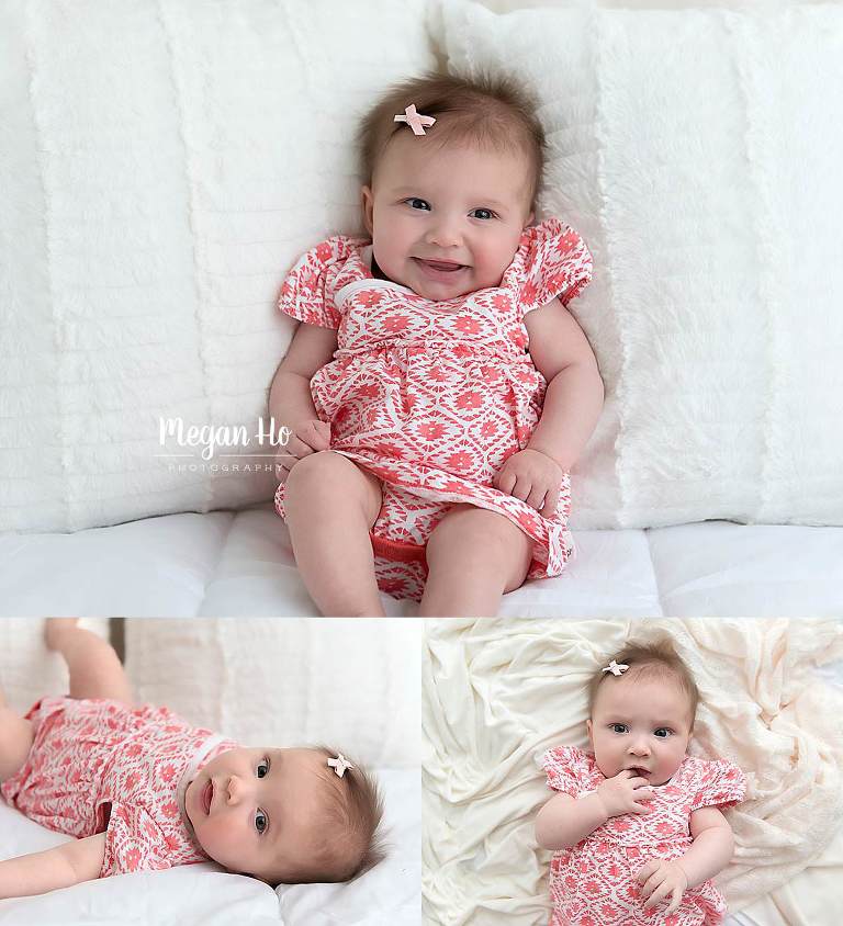 four month old girl giving lots of expressions in red dress with little bow