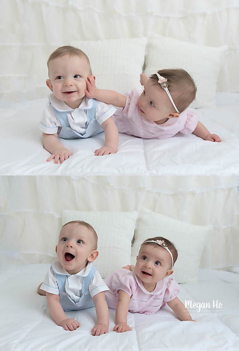 adorable twins laying on belly smiling and touching each others face