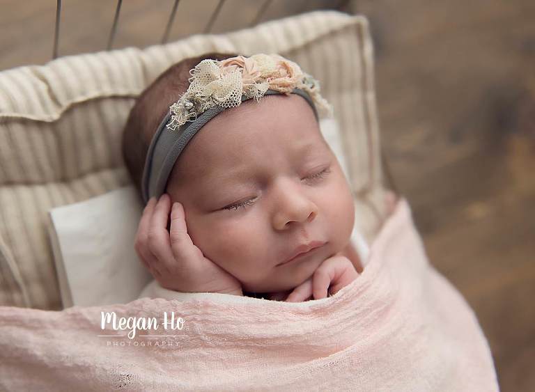 little girl tucked in to a little wire bed with tiny pillow in nh studio