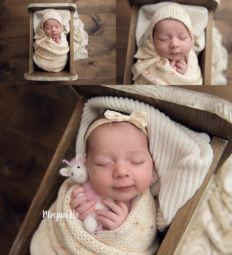 sweetly wrapped up baby girl in knit yellow blankets in little brown bed