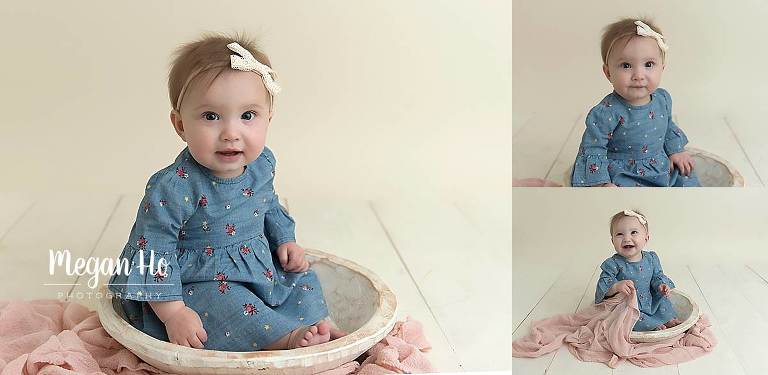 cutest little seven month old sitting in bowl on white wood floor