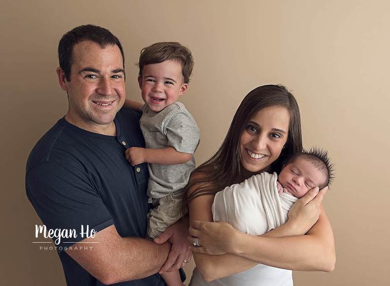 adorable family of four with brand new baby brother in southern nh studio session