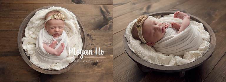 baby girl wrapped in white with feet out on lace blanket in wood bowl