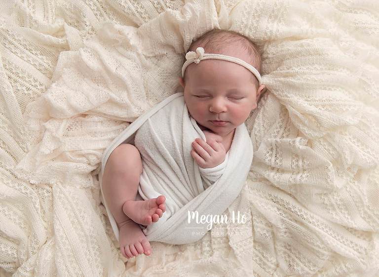 sweet baby girl in nh studio wrapped and lacing in white lace