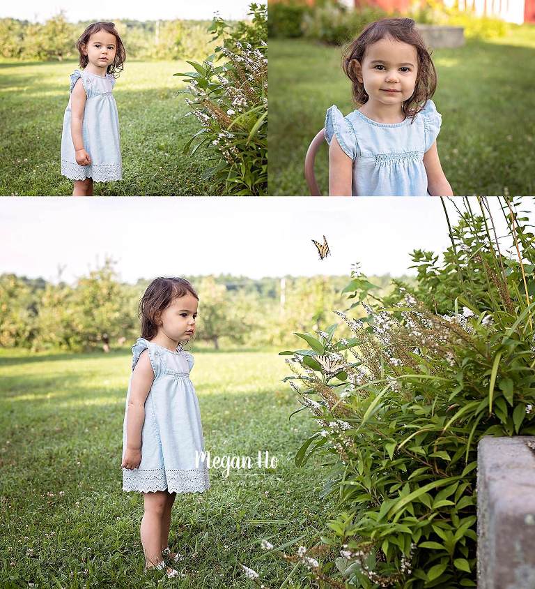 sweet little girl looking at flowers with butterflies flying around
