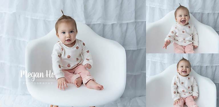 smiling one year old in white chair in Southern nh studio