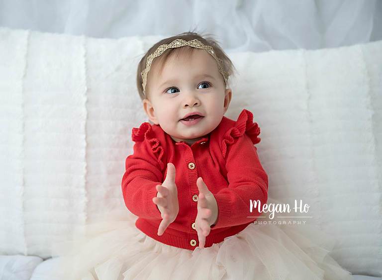happy clapping baby girl in red sweater in bedford nh