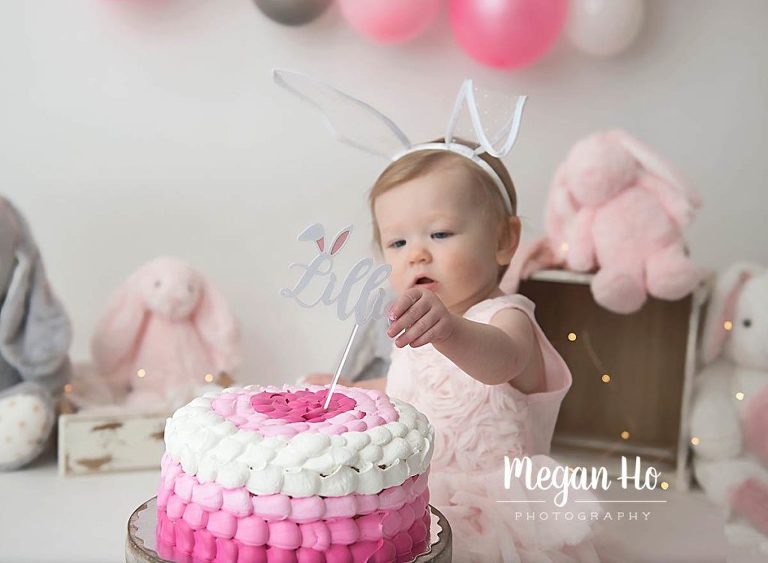 cutest little girl pulling cake topper off cake in NH studio session