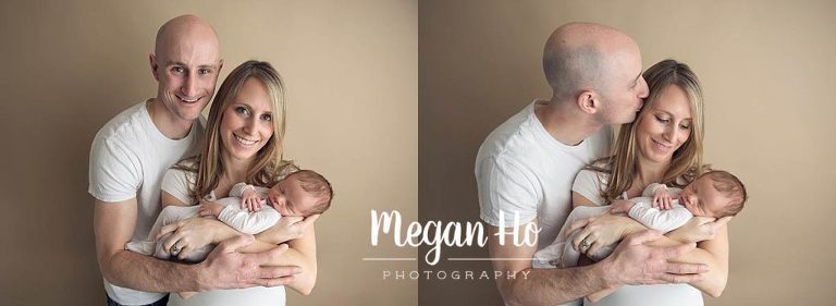 mom and dad lovingly holding their newborn baby boy in photography session