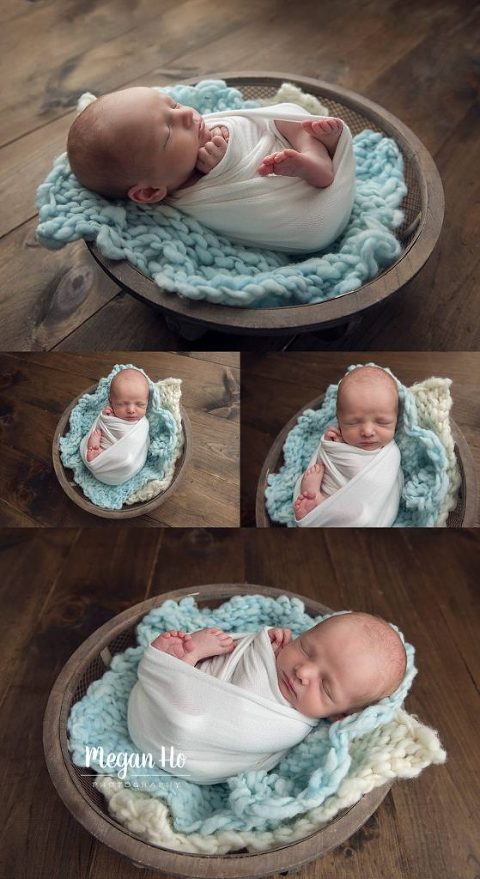 adorable sleepy baby boy laying in wire basket on white and blue knit blanket