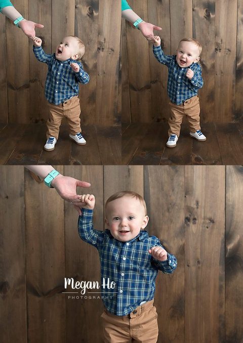 happiest little boy standing and holding onto mamas hand