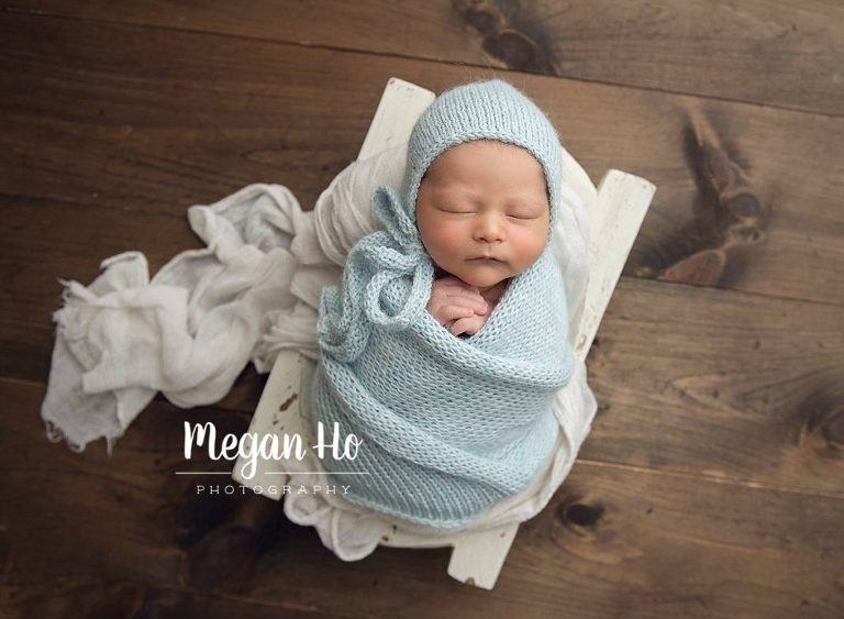 studio newborn session baby boy in blue knit on white trencher