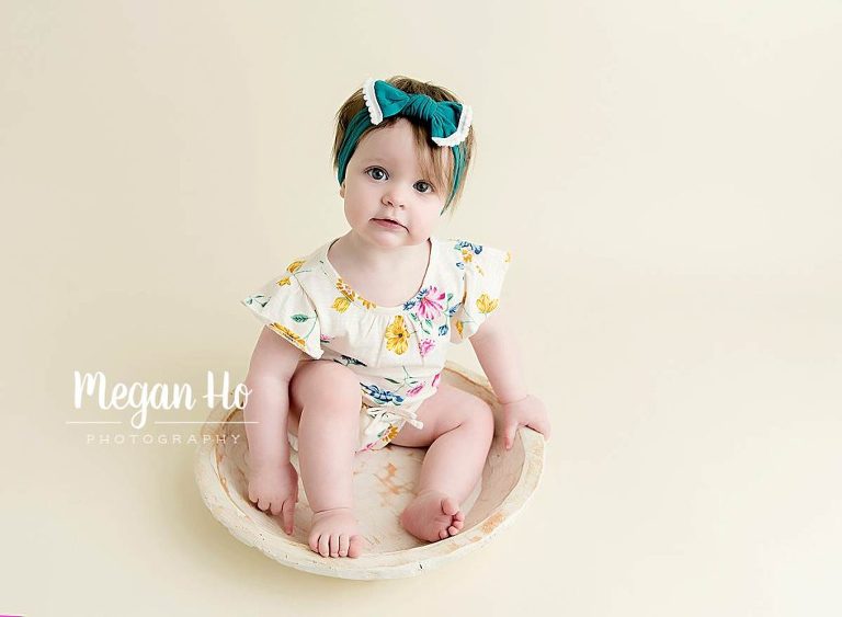 adorable little girl in turquoise headband in one year session