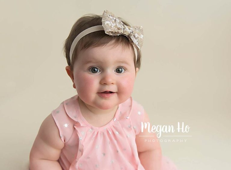 adorable smiling baby girls face in pink and silver dress