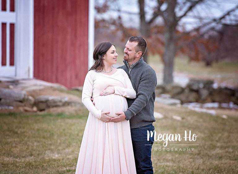 parents to be gazing lovingly in New Hampshire maternity session
