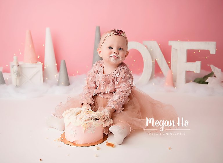 little girl sitting with cake in studio session